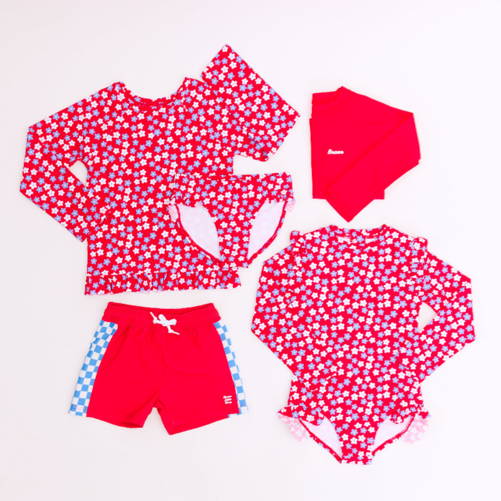Red and white patterned children's swim set with matching accessories on a white background