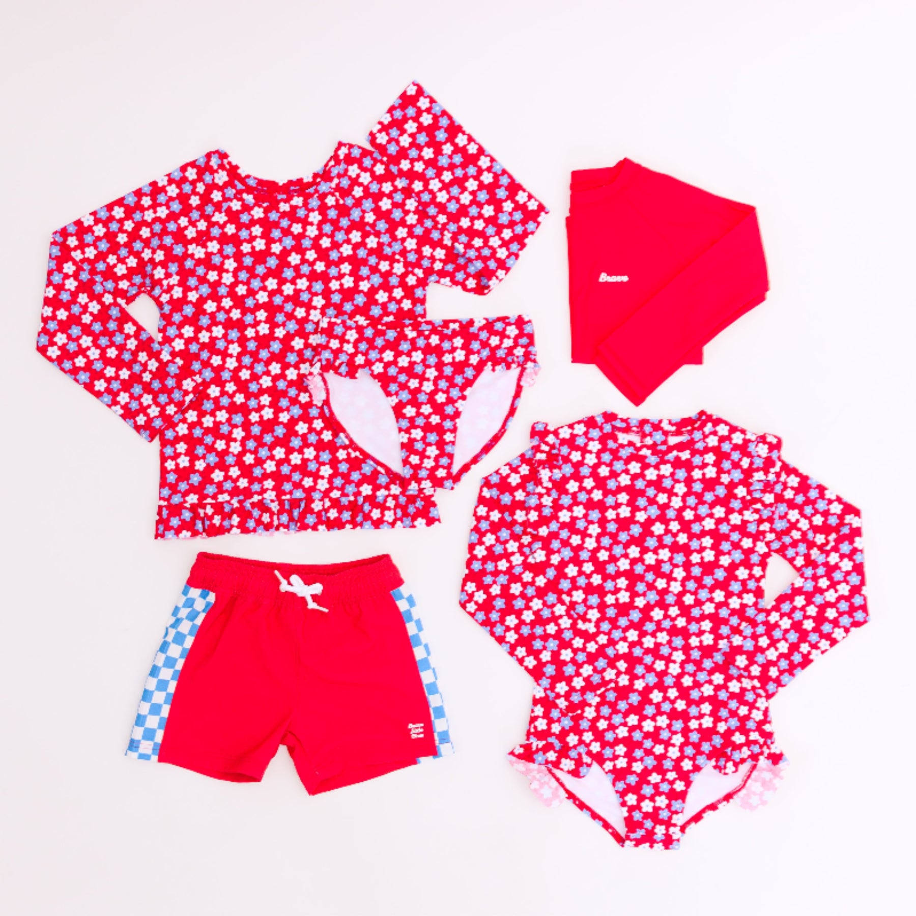 Red and white patterned children's swim set with matching accessories on a white background