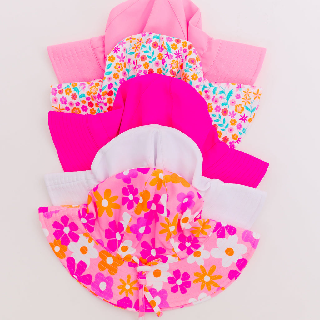 Set of colorful sun hats on a plain background