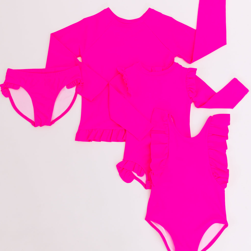 Bright pink swimsuits in different styles on a white background.
