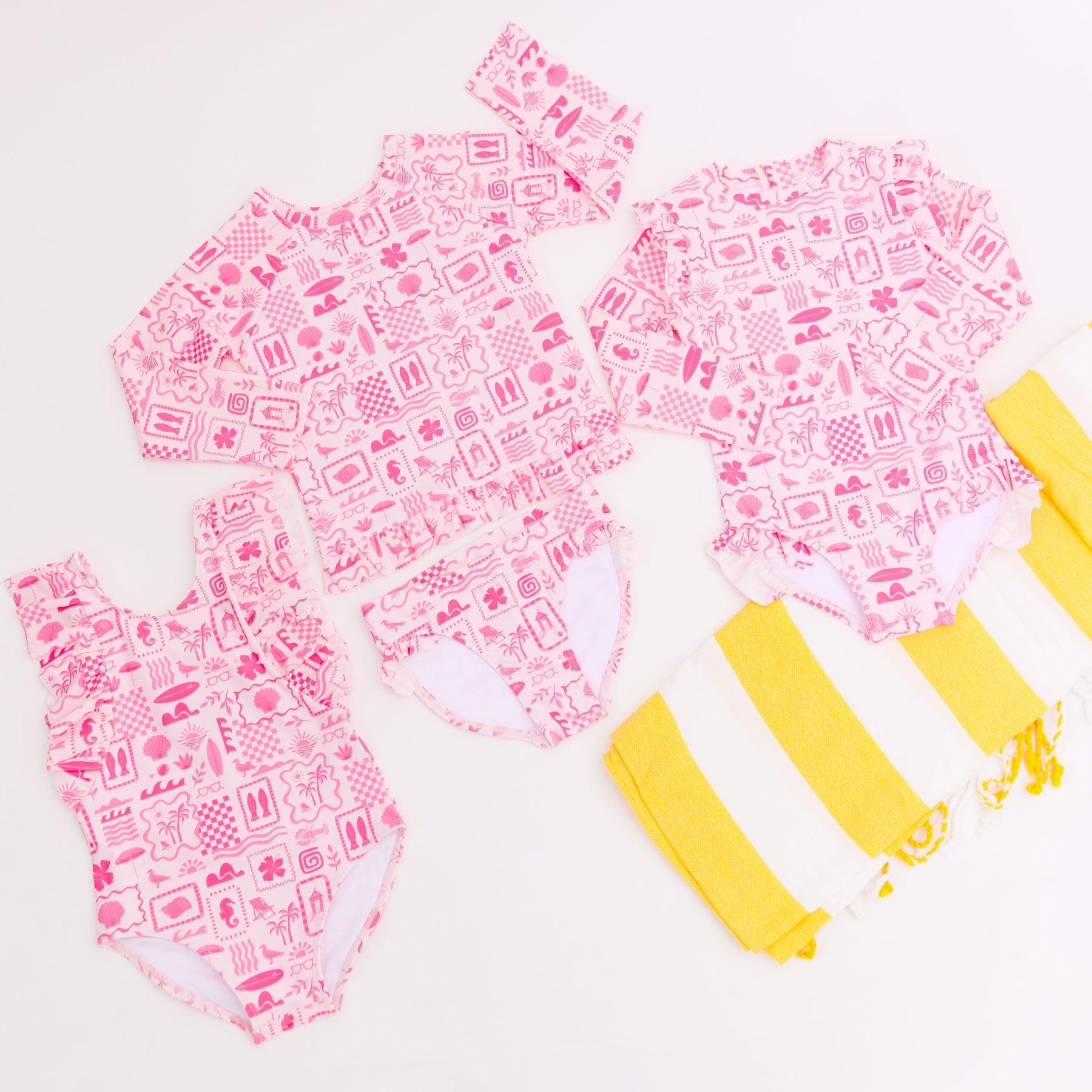 Pink and white patterned swimsuits with a yellow and white striped fabric on a white background