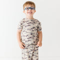 Child wearing a camouflage short pajamas on a white background