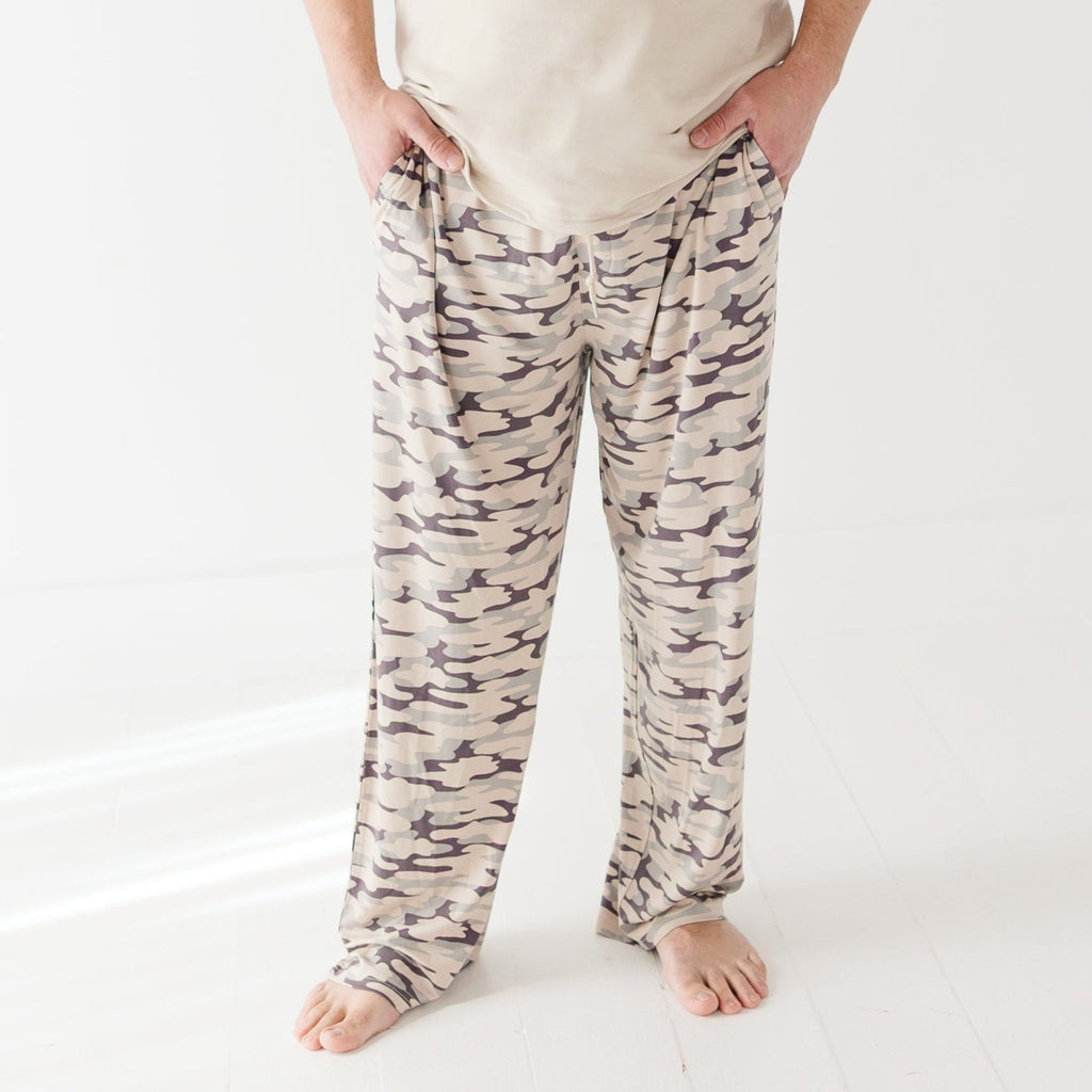 Person wearing camouflage pants on a white background