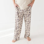 Person wearing camouflage pants on a white background