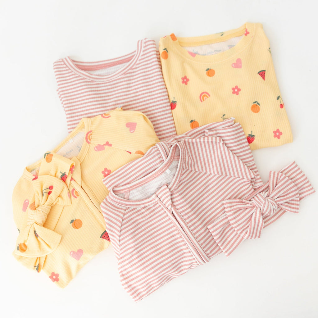 Children's different pajama sets with yellow and pink striped patterns on a white background