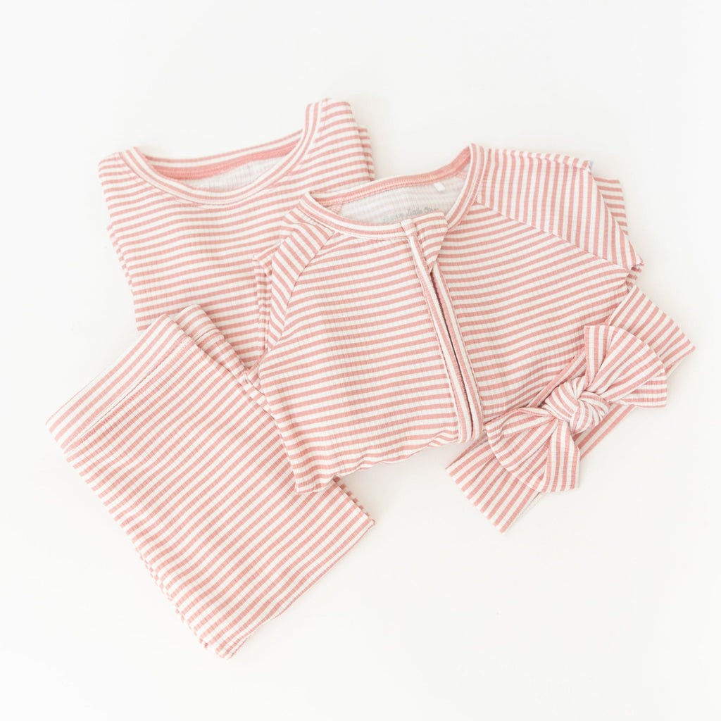 Pink striped pajama set on a white background