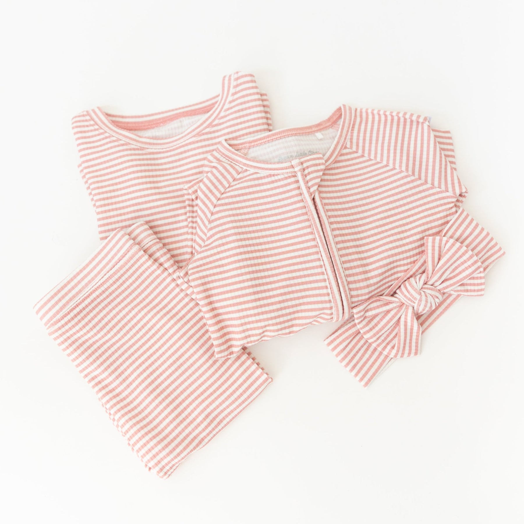 Pink striped pajama set on a white background
