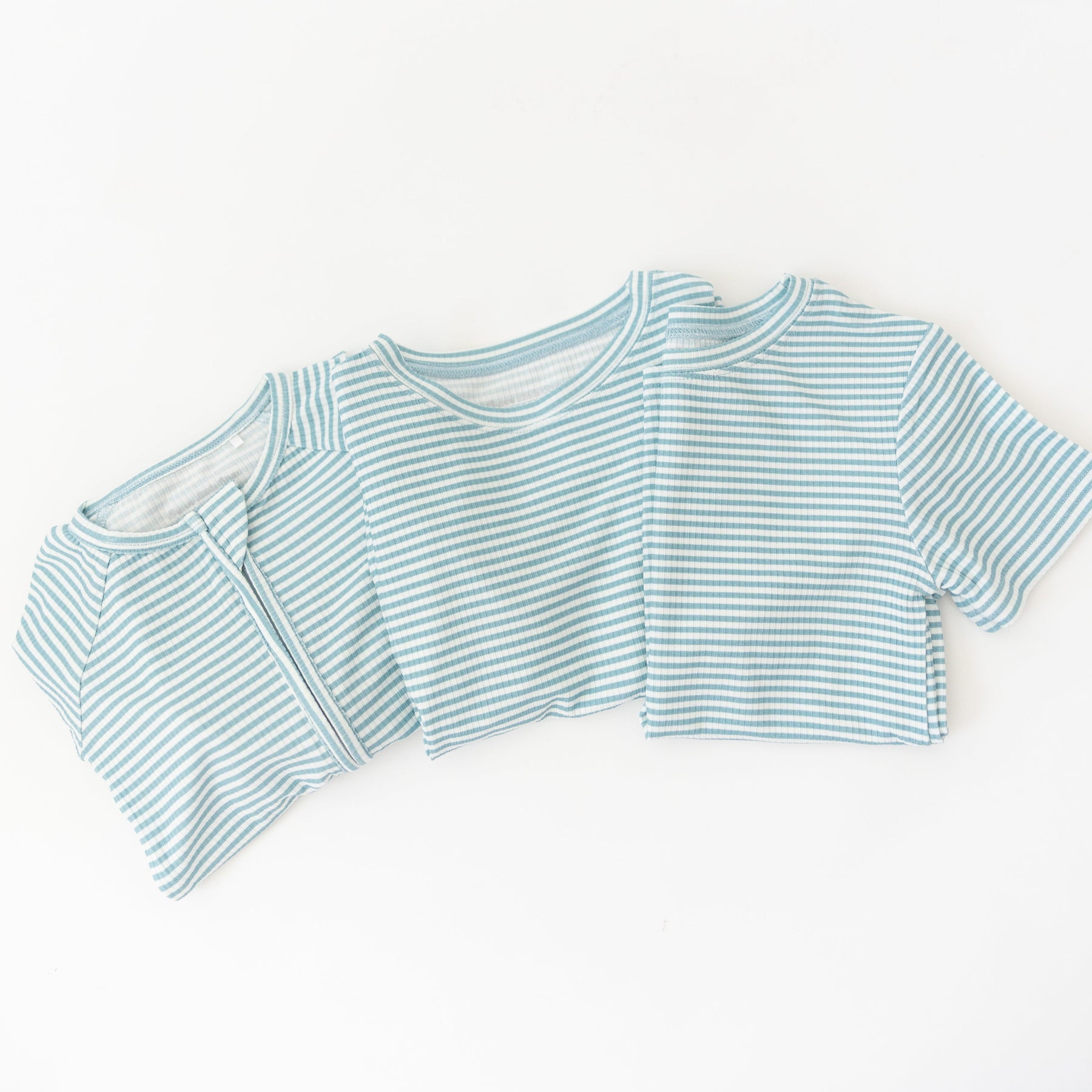 Blue and white striped pajama sets on a white background