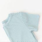 Folded blue and white striped shirt on a light background