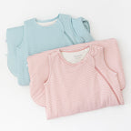 Two striped sleeping bags, one blue and white, one pink and white, on a white background