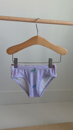 Video of a set of three children's underwear with different girly patterns hanging on a rack