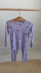 Video of a children's pajama set with unicorn patterns hanging on a rack