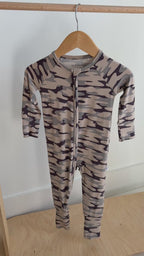 Camouflage-patterned onesie hanging on a rack