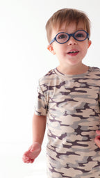 Video of a child wearing a camouflage short pajamas on a white background