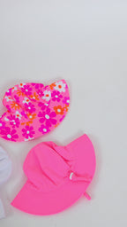 Set of colorful sun hats on a plain background