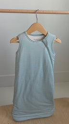 Video of a blue and white striped sleep sack hanging on a rack