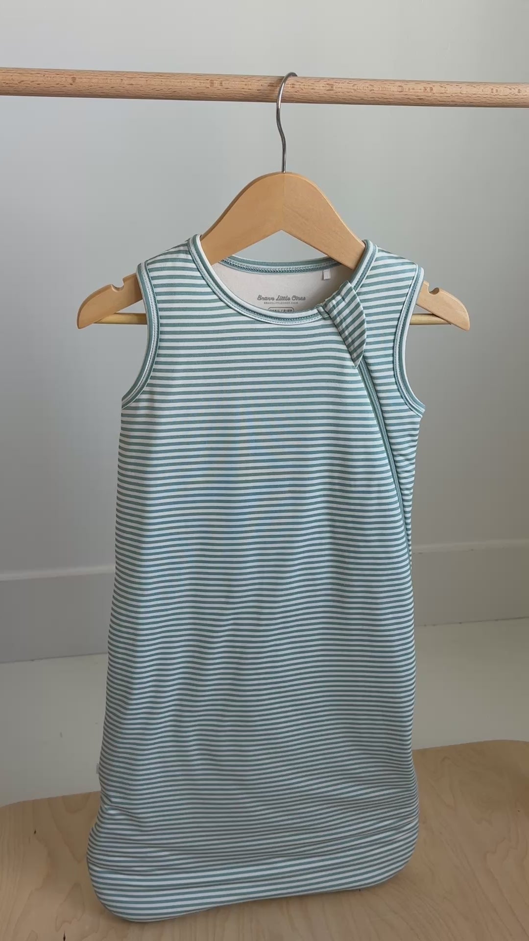 Video of a blue and white striped sleep sack hanging on a rack