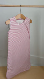 Pink striped sleeping bag hanging on a rack