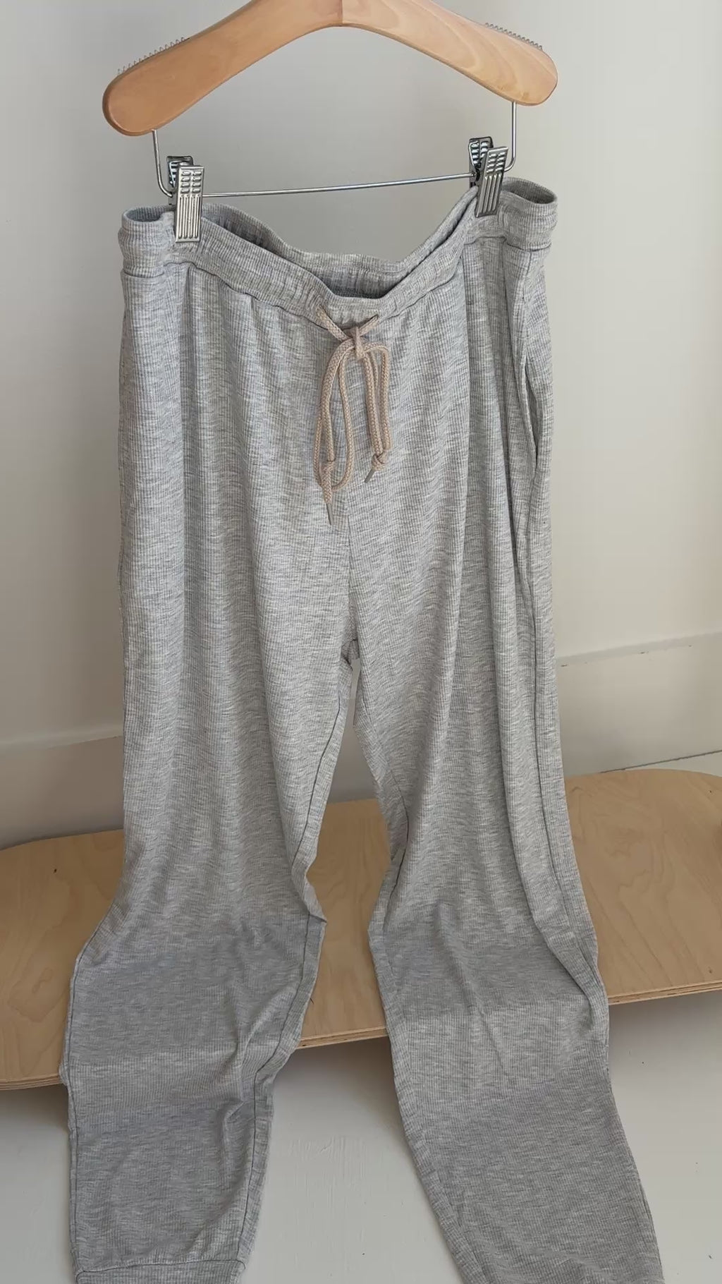 Gray pajama pants hanging on a rack