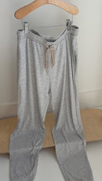 Gray pajama pants hanging on a rack