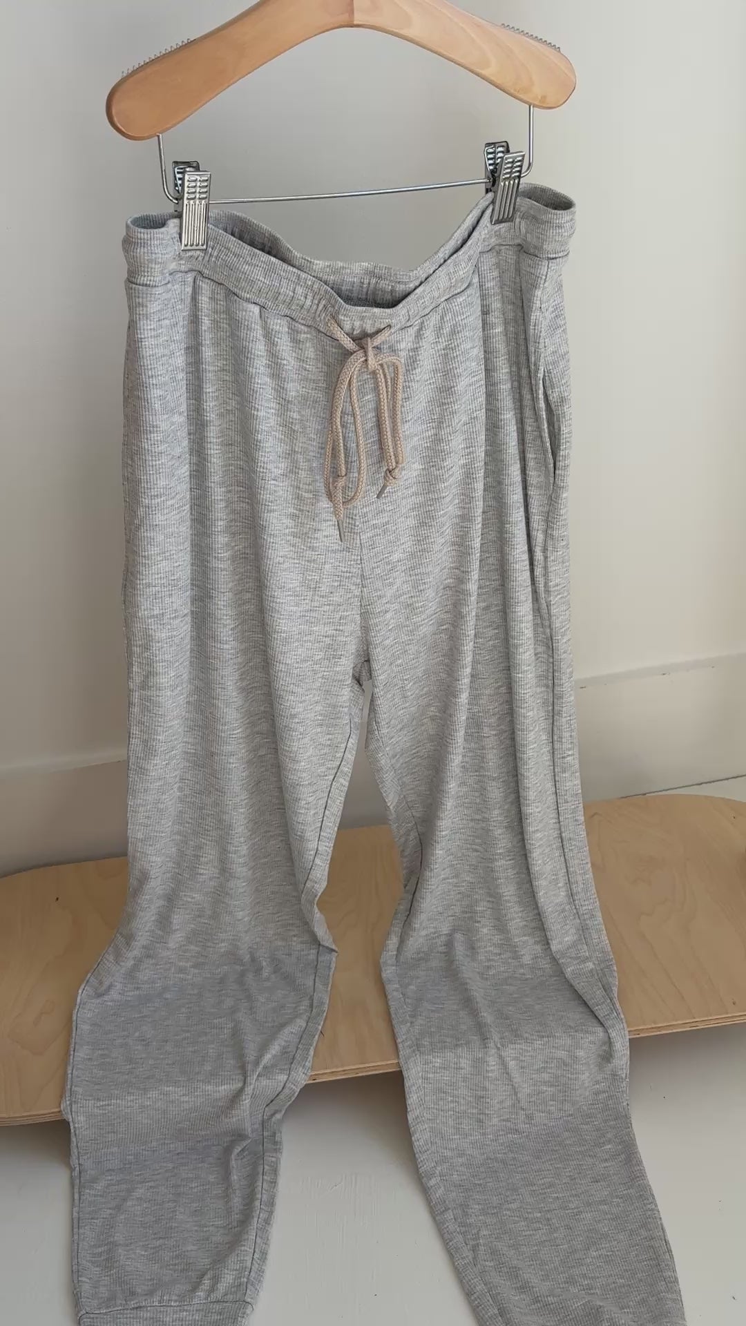 Gray pajama pants hanging on a rack
