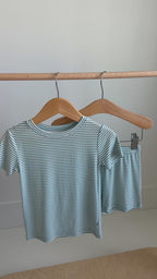 Striped t-shirt and shorts set hanging on a rack