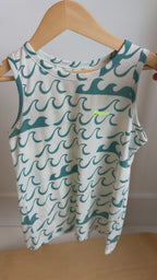 Tank top with blue wave pattern hanging on a rack