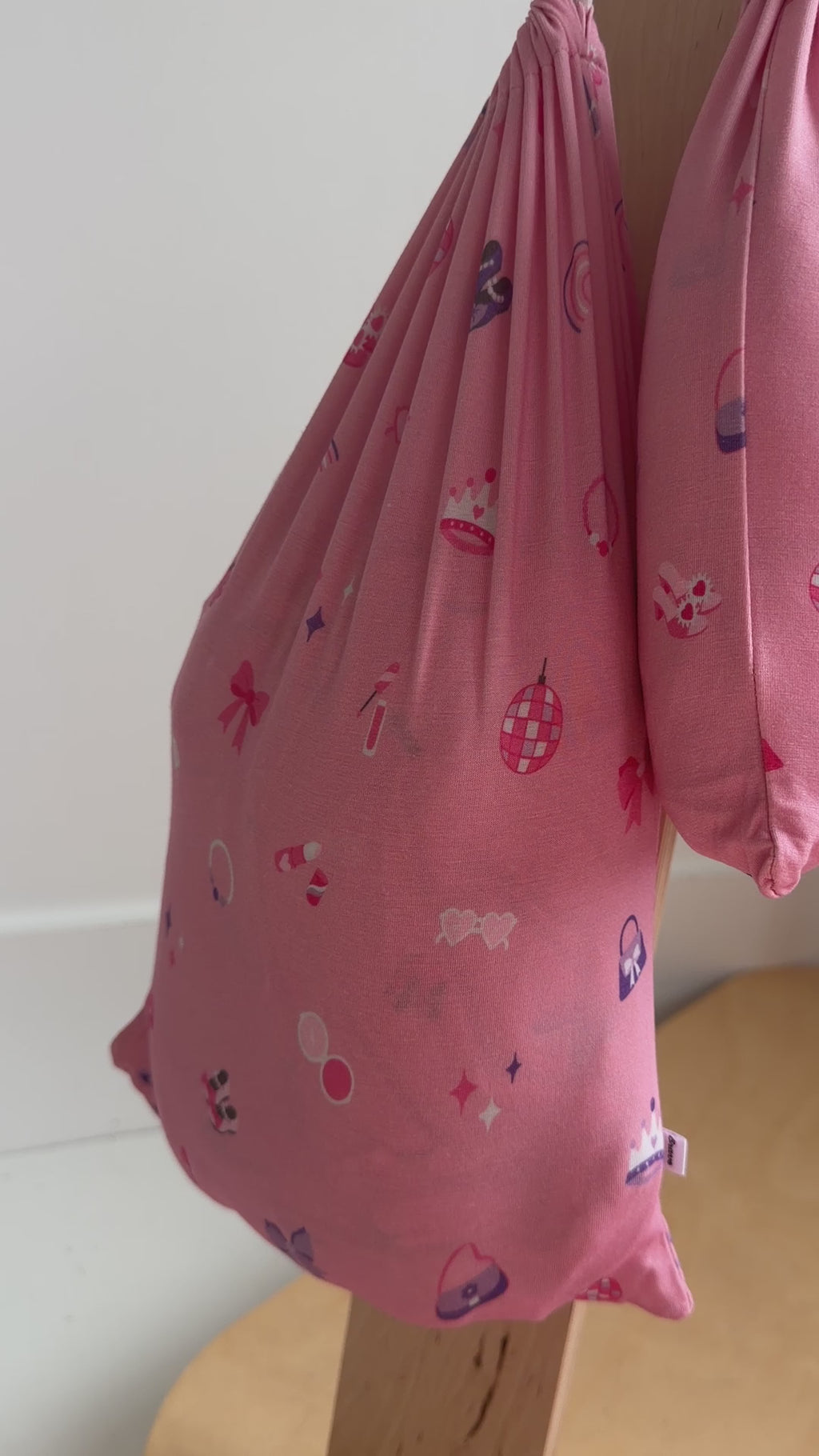 Video of a children's pink sheets hanging on a rack