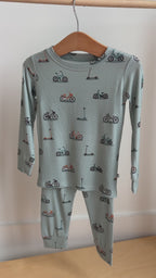 Video of a children's pajama set with bikes and scooter pattern hanging on a rack
