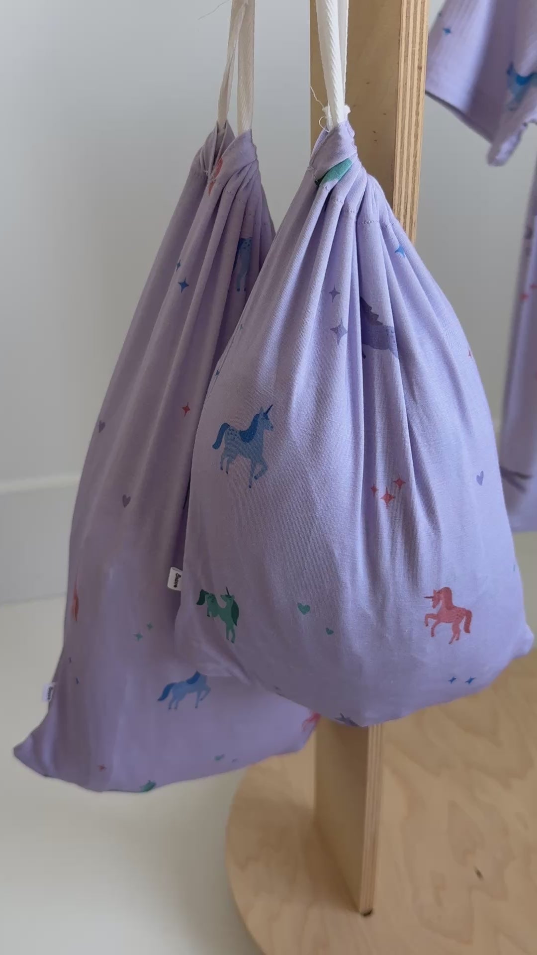 Bed sheets of colorful unicorn patterns hanging on a rack