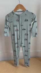 Video of a children's onesie with bicycles & scooters pattern hanging on a rack
