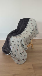 Blanket with off-road vehicle pattern draped over a chair