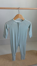 Video of a blue and white striped baby onesie on a white background